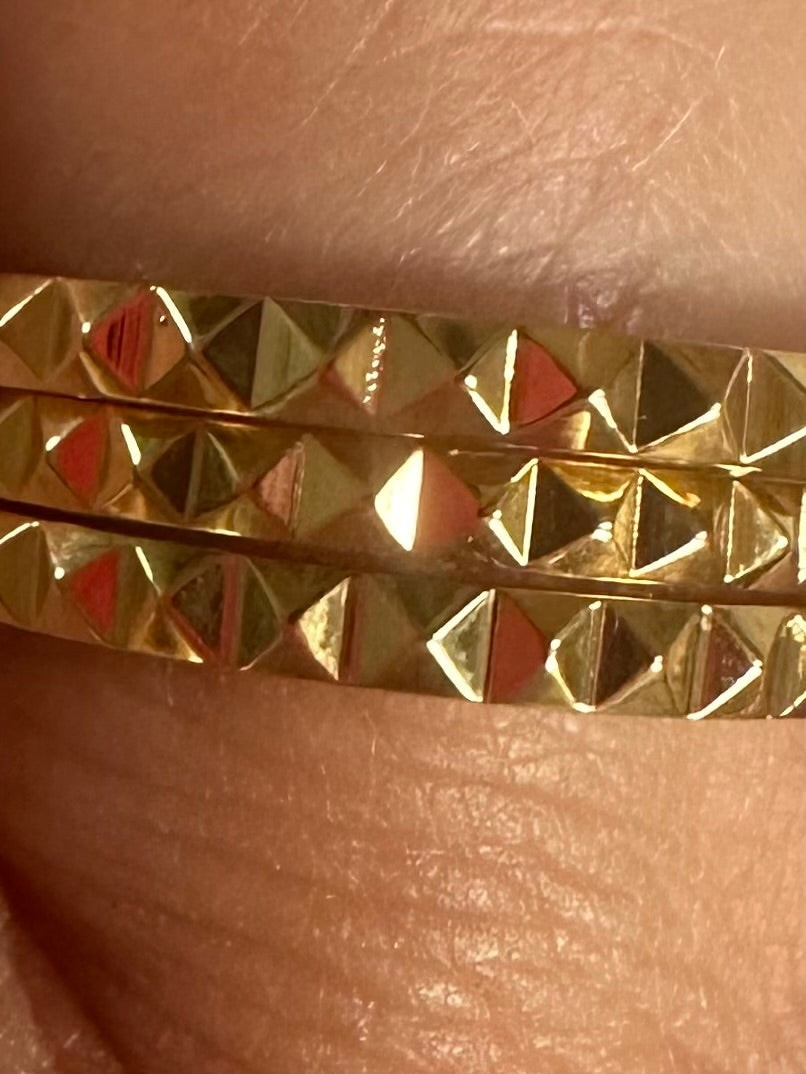 Alokaluca Radiant Edge Ring in gold-tone stainless steel featuring a faceted pointed band design on a finger