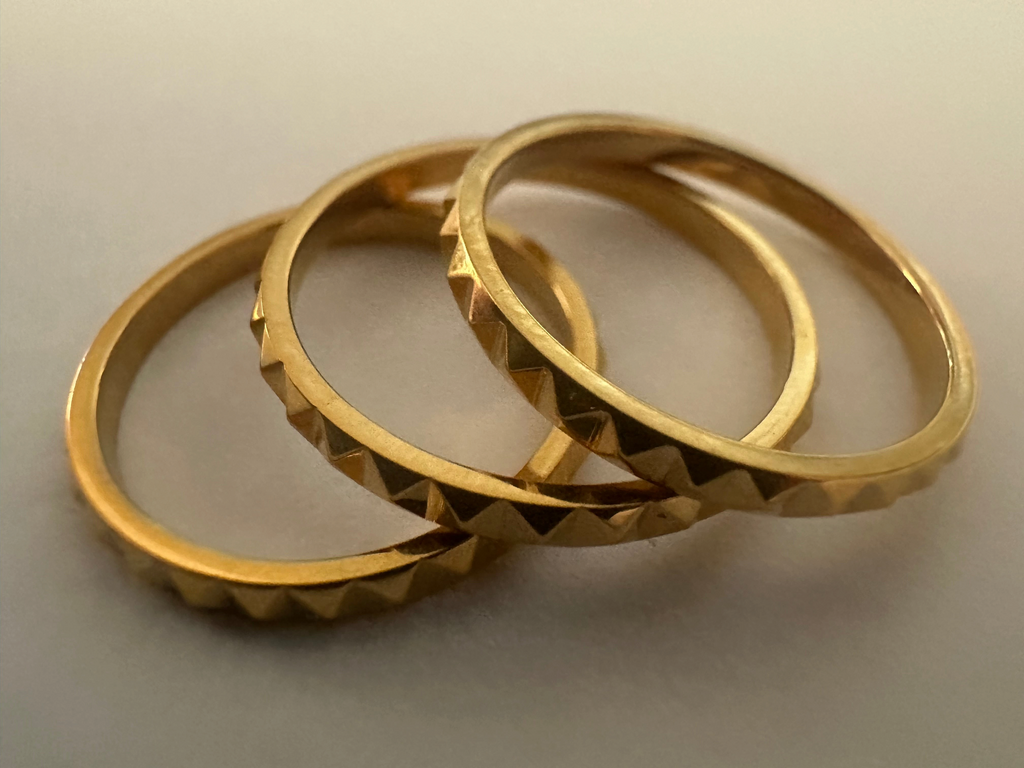 Alokaluca Radiant Edge Ring featuring a faceted gold-tone stainless steel band with a sculptural pointed design.
