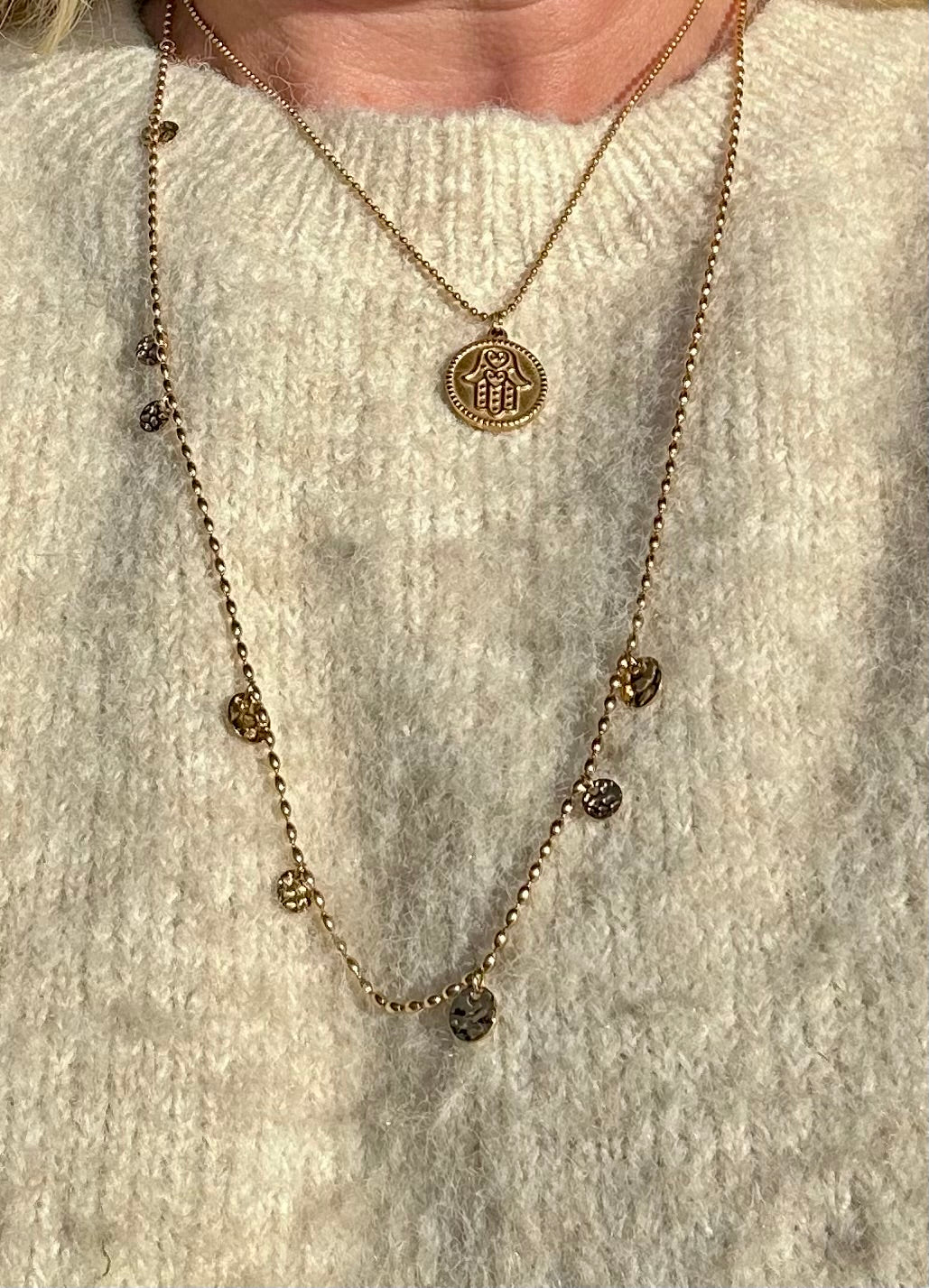 Circle of Light Necklace worn layered with a gold pendant necklace